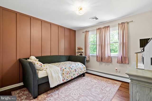 126 Woodview Dr, Doylestown, PA 18901 - bedroom with a baseboard heating unit and wood finished floors