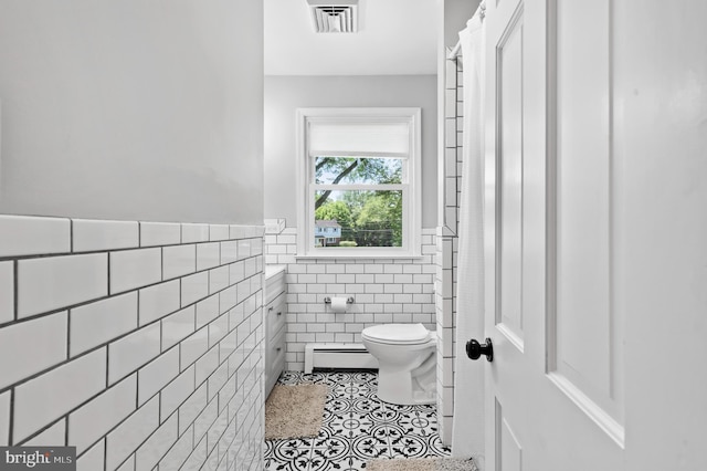 126 Woodview Dr, Doylestown, PA 18901 - bathroom with tile walls, tile patterned floors, a baseboard radiator, a wainscoted wall, and vanity