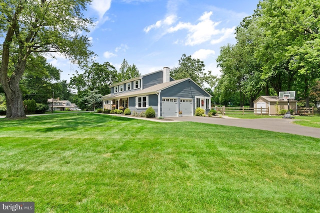 126 Woodview Dr, Doylestown, PA 18901 - view of front of house featuring a chimney, asphalt driveway, an attached garage, and a storage shed