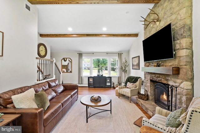 126 Woodview Dr, Doylestown, PA 18901 - living area with a fireplace, beamed ceiling, wood finished floors, stairway, and a baseboard radiator