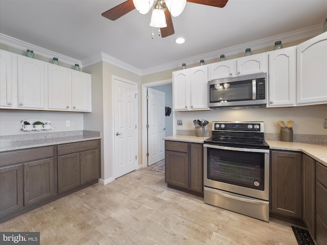 101 Carrera Ct, Inwood, WV 25428 - kitchen featuring stainless steel appliances, ceiling fan, white cabinetry, light countertops, and crown molding