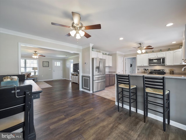 101 Carrera Ct, Inwood, WV 25428 - kitchen with appliances with stainless steel finishes, a ceiling fan, crown molding, white cabinetry, and light countertops
