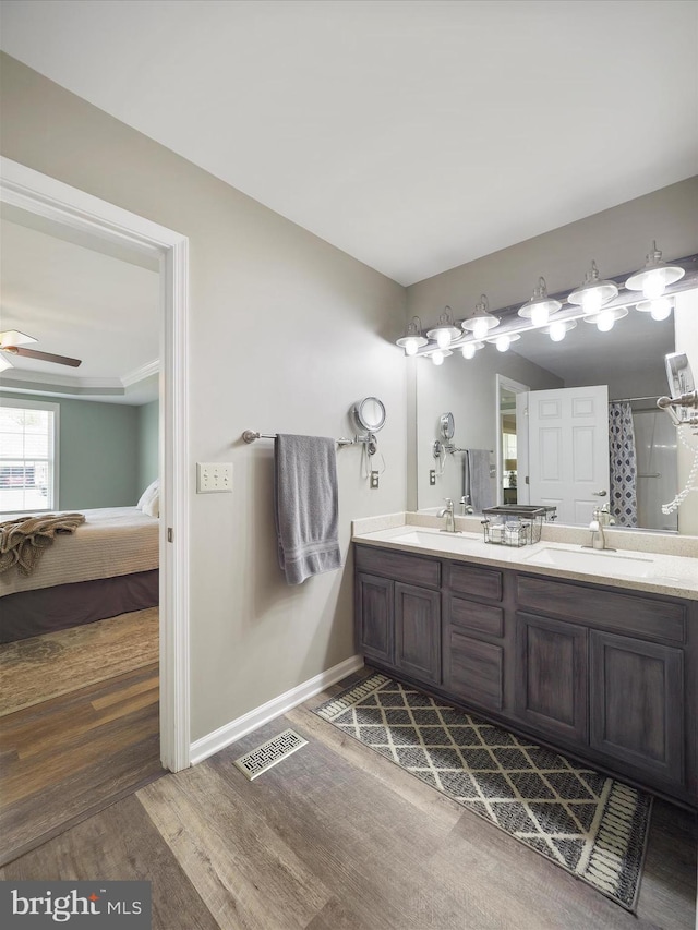 101 Carrera Ct, Inwood, WV 25428 - ensuite bathroom featuring double vanity, wood finished floors, ceiling fan, and a shower with curtain