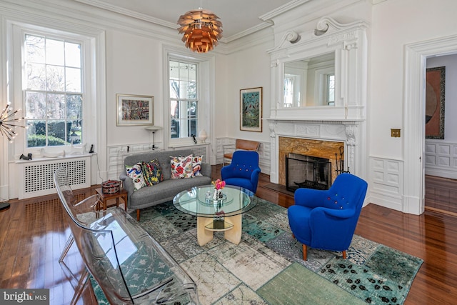 15 Hodge Rd, Princeton, NJ 08540 - living area with wood finished floors, radiator, a fireplace, ornamental molding, and wainscoting