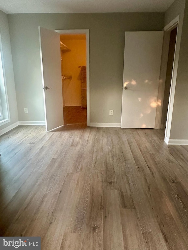 3176 Summit Square Dr Unit 4-D7, Oakton, VA 22124 - unfurnished bedroom with wood finished floors and a walk in closet