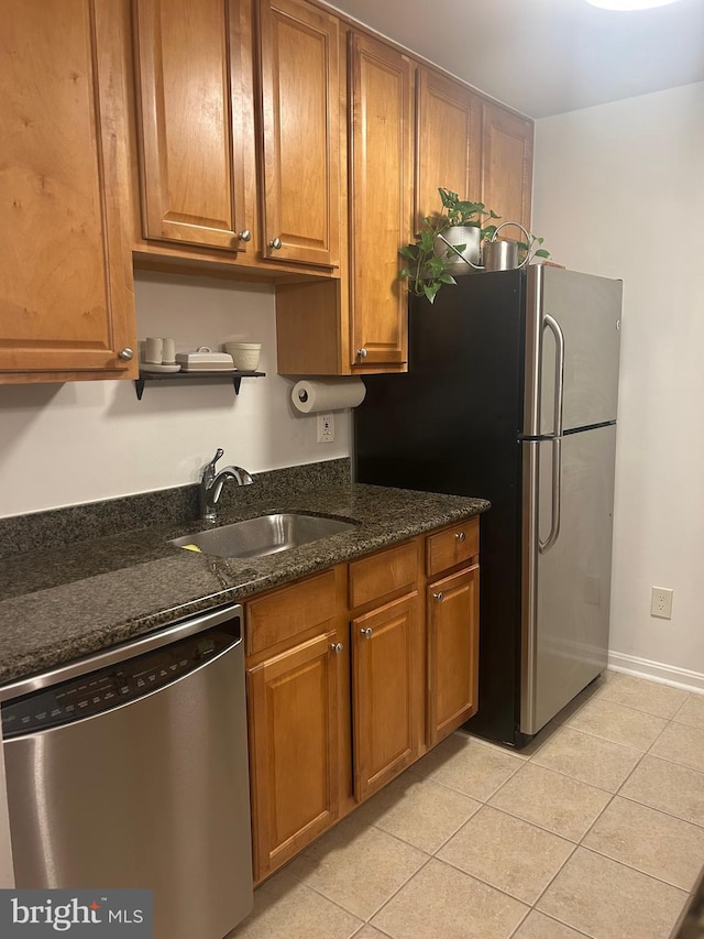 3176 Summit Square Dr Unit 4-D7, Oakton, VA 22124 - kitchen with stainless steel appliances, light tile patterned flooring, brown cabinets, and dark stone counters