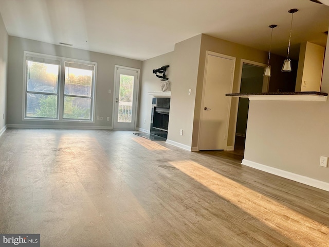 3176 Summit Square Dr Unit 4-D7, Oakton, VA 22124 - unfurnished living room featuring a fireplace and wood finished floors