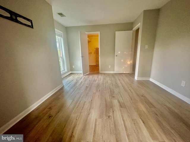 3176 Summit Square Dr Unit 4-D7, Oakton, VA 22124 - unfurnished bedroom featuring wood finished floors and a walk in closet