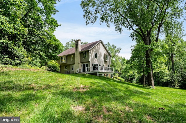 211 Fox Ln, Wallingford, PA 19086 - rear view of house featuring a chimney, a deck, and a lawn