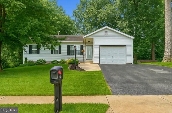 3624 Harrowgate Rd, York, PA 17402 - ranch-style house with a garage, asphalt driveway, and a front yard
