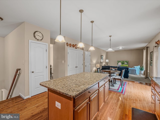 158 Dinwiddie Way, Kearneysville, WV 25430 - kitchen featuring brown cabinets, light wood finished floors, open floor plan, and a center island