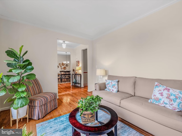 158 Dinwiddie Way, Kearneysville, WV 25430 - living room featuring wood finished floors, ornamental molding, and a chandelier