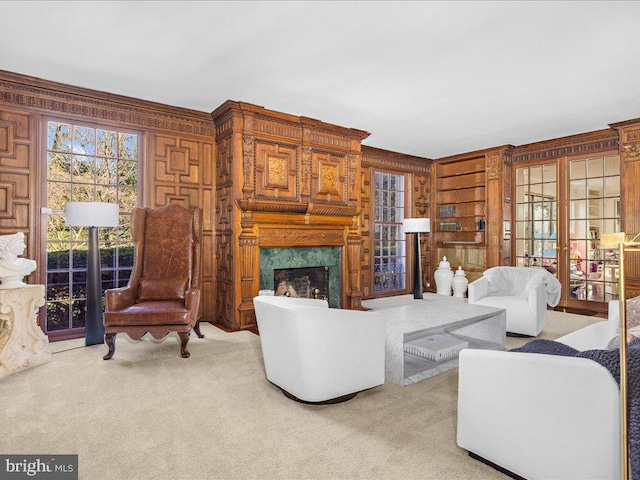 4332 N Charles St, Baltimore, MD 21218 - living area featuring wooden walls, a high end fireplace, carpet flooring, and crown molding