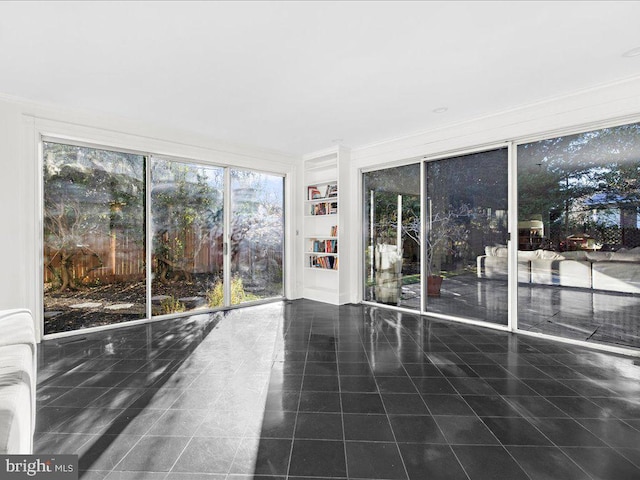 4332 N Charles St, Baltimore, MD 21218 - empty room with tile patterned floors, crown molding, and built in features
