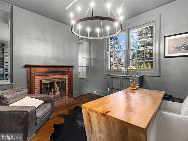 4332 N Charles St, Baltimore, MD 21218 - living room with wood finished floors, a chandelier, and a brick fireplace