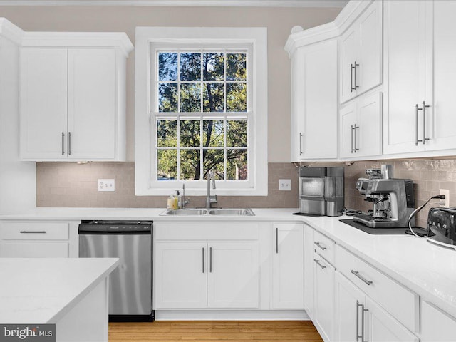 4332 N Charles St, Baltimore, MD 21218 - kitchen featuring stainless steel dishwasher, healthy amount of natural light, light countertops, and white cabinetry