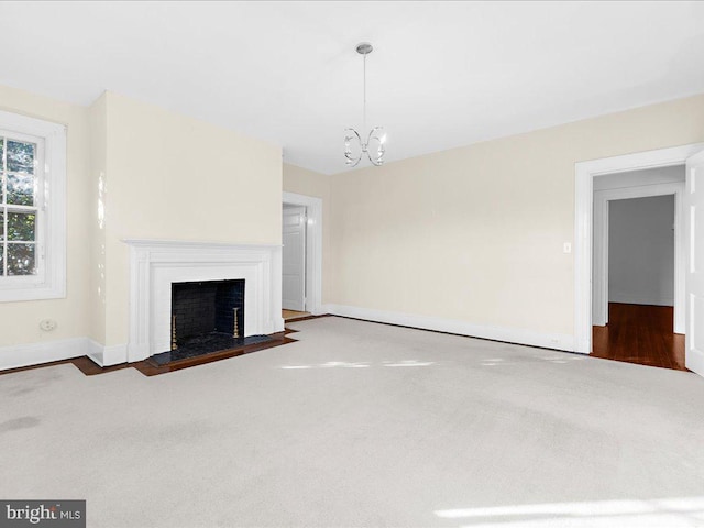 4332 N Charles St, Baltimore, MD 21218 - unfurnished living room featuring a chandelier, a fireplace with flush hearth, and carpet flooring