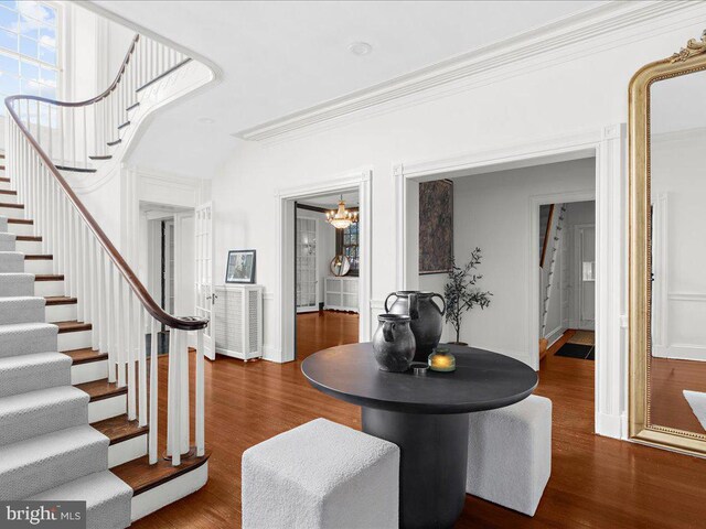 4332 N Charles St, Baltimore, MD 21218 - foyer featuring stairs, ornamental molding, a chandelier, and wood finished floors