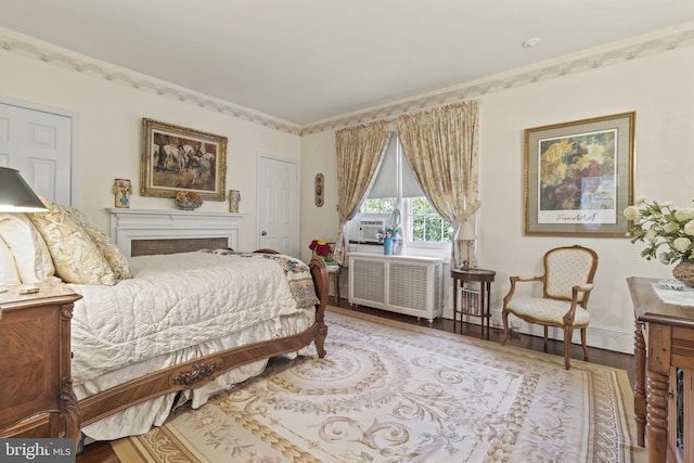 4332 N Charles St, Baltimore, MD 21218 - bedroom featuring radiator, wood finished floors, and cooling unit