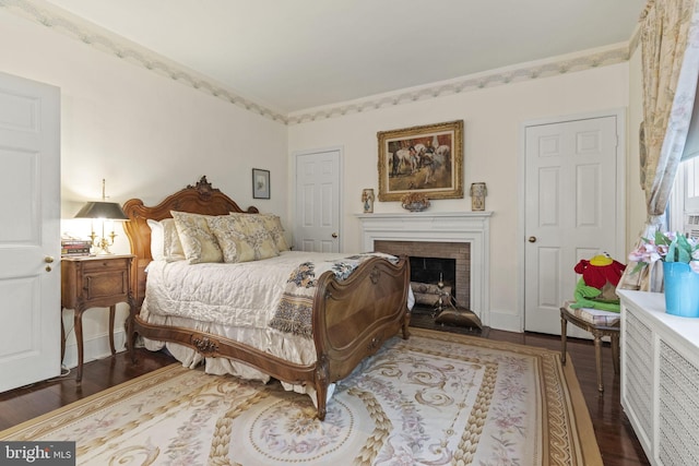 4332 N Charles St, Baltimore, MD 21218 - bedroom with wood finished floors and a brick fireplace