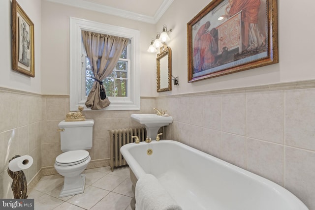 4332 N Charles St, Baltimore, MD 21218 - bathroom with radiator heating unit, a freestanding tub, ornamental molding, tile patterned flooring, and tile walls