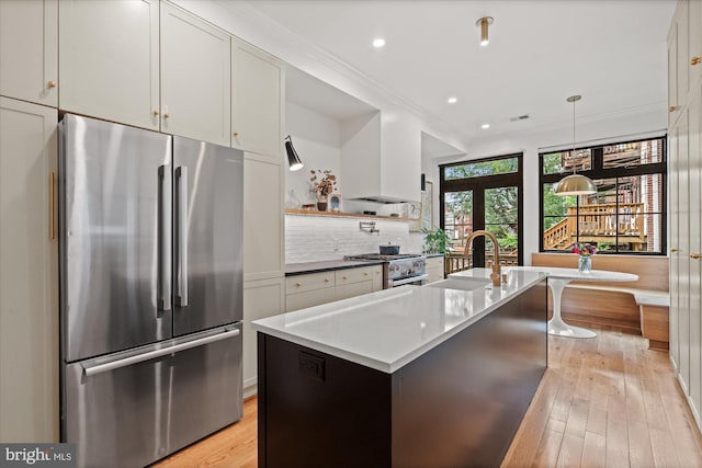 7 U St NW, Washington, DC 20001 - kitchen with stainless steel appliances, light wood finished floors, crown molding, tasteful backsplash, and recessed lighting
