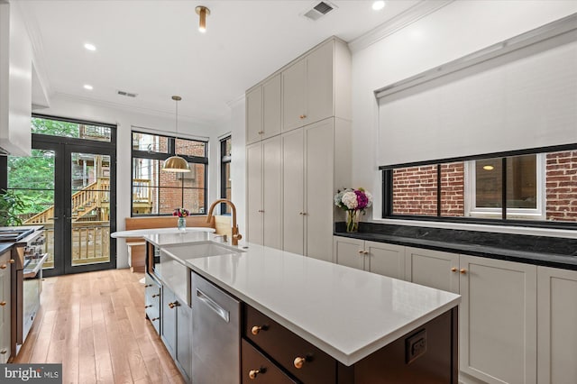 7 U St NW, Washington, DC 20001 - kitchen featuring stainless steel appliances, light wood-type flooring, crown molding, a center island with sink, and pendant lighting