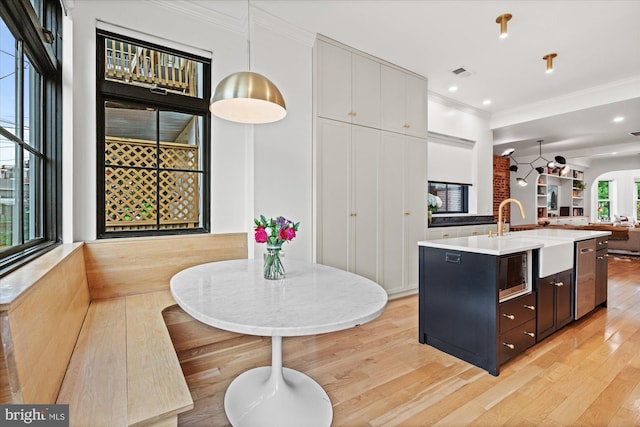 7 U St NW, Washington, DC 20001 - kitchen featuring open floor plan, ornamental molding, stainless steel appliances, light wood-style flooring, and light countertops
