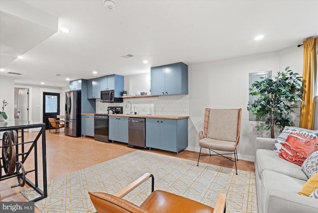 7 U St NW, Washington, DC 20001 - kitchen with stainless steel appliances, blue cabinetry, decorative backsplash, butcher block counters, and open shelves
