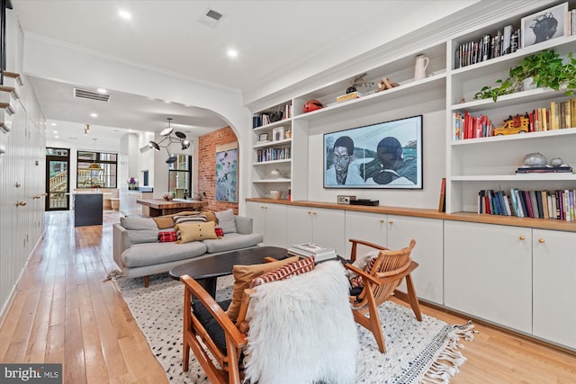 7 U St NW, Washington, DC 20001 - living room featuring arched walkways, light wood-style flooring, crown molding, and built in features