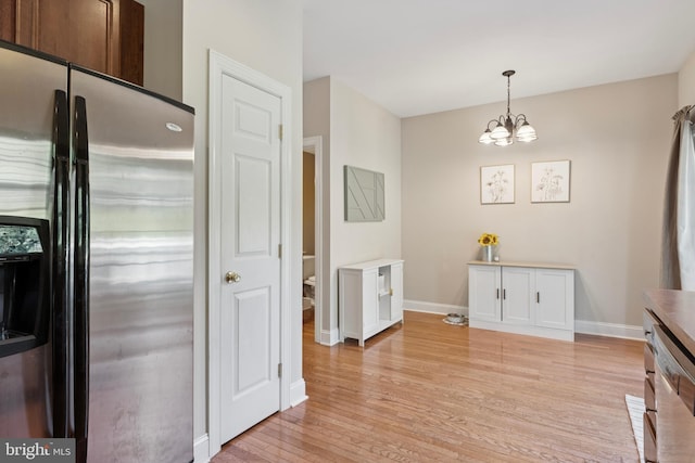 31 Hoag Ln, Aston, PA 19014 - kitchen featuring stainless steel fridge with ice dispenser, light wood-style flooring, a chandelier, and hanging light fixtures