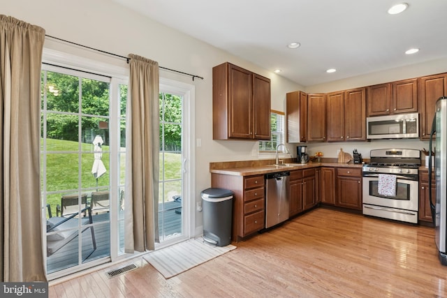 31 Hoag Ln, Aston, PA 19014 - kitchen featuring stainless steel appliances, light wood finished floors, plenty of natural light, recessed lighting, and brown cabinets