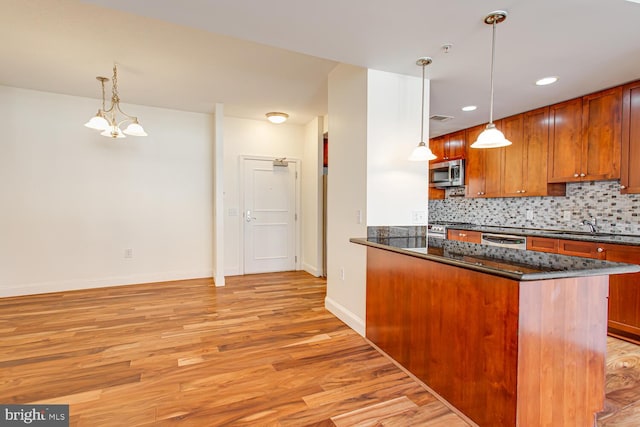 3650 S Glebe Rd Unit 239, Arlington, VA 22202 - kitchen with stainless steel appliances, light wood-type flooring, backsplash, brown cabinetry, and recessed lighting