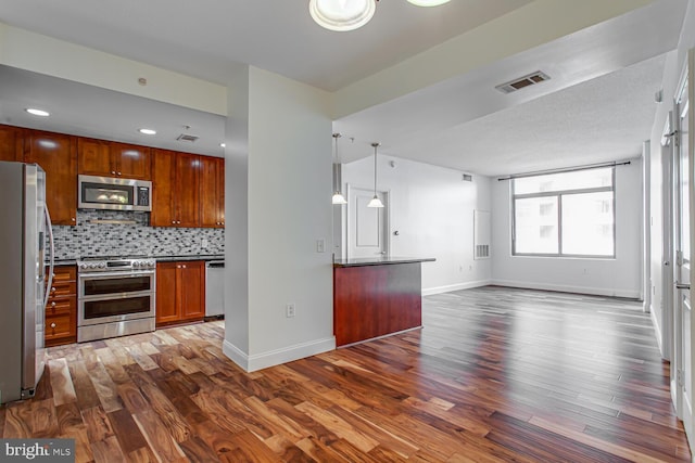 3650 S Glebe Rd Unit 239, Arlington, VA 22202 - kitchen featuring stainless steel appliances, open floor plan, dark wood-style floors, backsplash, and dark countertops