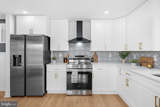 2910 Georgia Ave, Halethorpe, MD 21227 - kitchen with appliances with stainless steel finishes, wall chimney range hood, light countertops, light wood finished floors, and recessed lighting