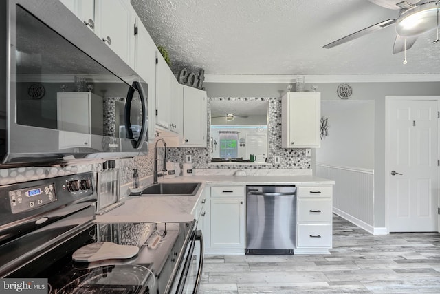 840 W Spring Meadow Ct, Edgewood, MD 21040 - kitchen featuring appliances with stainless steel finishes, ceiling fan, ornamental molding, light wood-style floors, and white cabinets