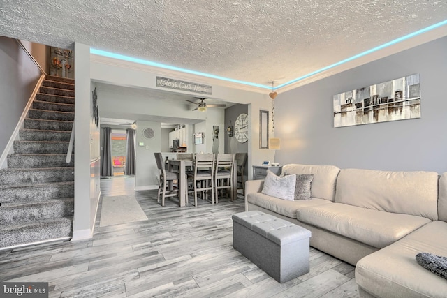 840 W Spring Meadow Ct, Edgewood, MD 21040 - living area with a textured ceiling, stairway, wood finished floors, and a ceiling fan