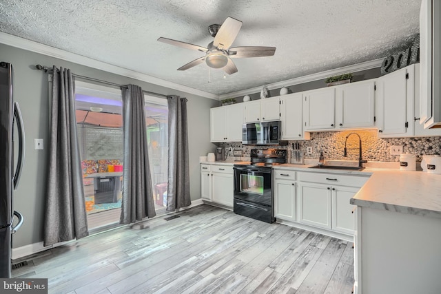 840 W Spring Meadow Ct, Edgewood, MD 21040 - kitchen featuring black range with electric cooktop, stainless steel microwave, crown molding, backsplash, and a ceiling fan