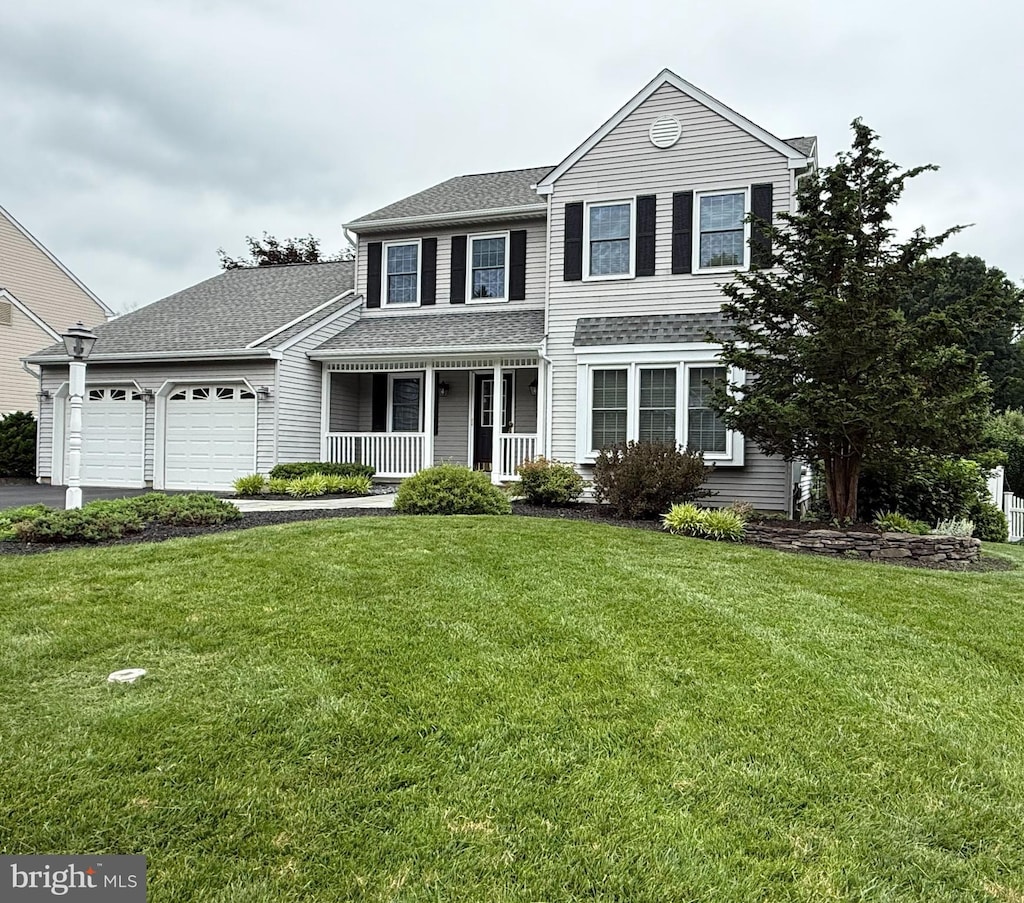 403 Mahogany Ct, Doylestown, PA 18901 - traditional-style home with a porch, a garage, a front lawn, and asphalt driveway