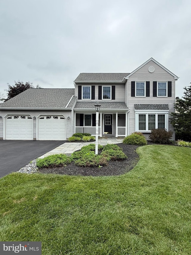 403 Mahogany Ct, Doylestown, PA 18901 - traditional-style house featuring an attached garage, covered porch, driveway, a front lawn, and roof with shingles