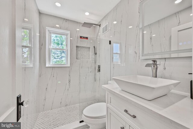 1539 K St SE, Washington, DC 20003 - bathroom featuring tile walls, vanity, a marble finish shower, and recessed lighting