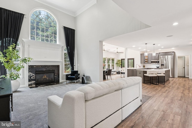1508 Cornerstone Ct, Crownsville, MD 21032 - living room with a fireplace, crown molding, recessed lighting, light wood finished floors, and a towering ceiling