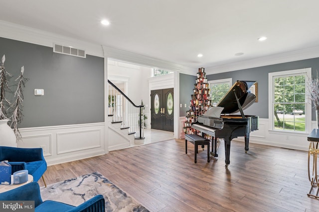 1508 Cornerstone Ct, Crownsville, MD 21032 - living area featuring stairs, crown molding, a wainscoted wall, wood finished floors, and a decorative wall