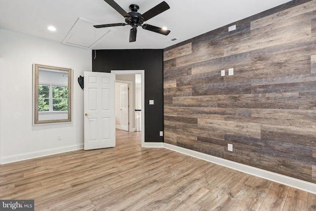 1508 Cornerstone Ct, Crownsville, MD 21032 - unfurnished room featuring attic access, a ceiling fan, wooden walls, an accent wall, and wood finished floors