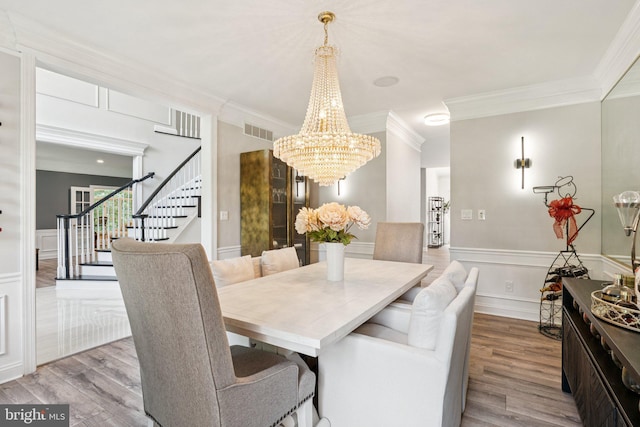 1508 Cornerstone Ct, Crownsville, MD 21032 - dining space with a chandelier, stairway, ornamental molding, wood finished floors, and wainscoting