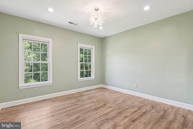 1508 Cornerstone Ct, Crownsville, MD 21032 - spare room with a chandelier, plenty of natural light, light wood-style flooring, and recessed lighting