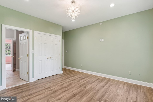 1508 Cornerstone Ct, Crownsville, MD 21032 - unfurnished bedroom featuring light wood-style flooring, a chandelier, a closet, and recessed lighting