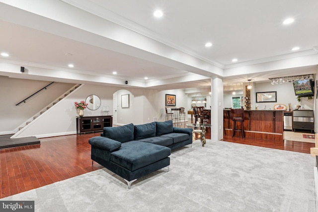 1508 Cornerstone Ct, Crownsville, MD 21032 - living room with wet bar, wood finished floors, stairs, ornamental molding, and recessed lighting