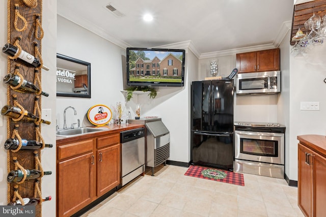 1508 Cornerstone Ct, Crownsville, MD 21032 - kitchen featuring appliances with stainless steel finishes, crown molding, and brown cabinetry