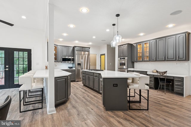 1508 Cornerstone Ct, Crownsville, MD 21032 - kitchen with stainless steel appliances, a breakfast bar area, a peninsula, gray cabinets, and recessed lighting